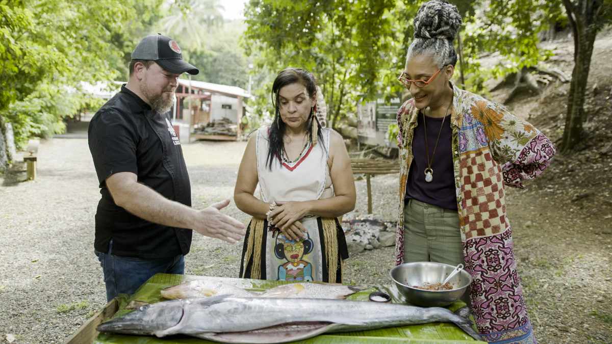 Carla about to BBQ a fish, as seen on Chasing Flavors, season 1.