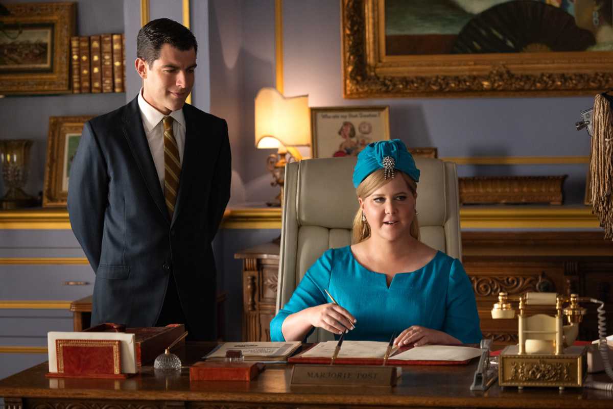 Max Greenfield as Rick Ludwin and Amy Schumer as Marjorie Post.