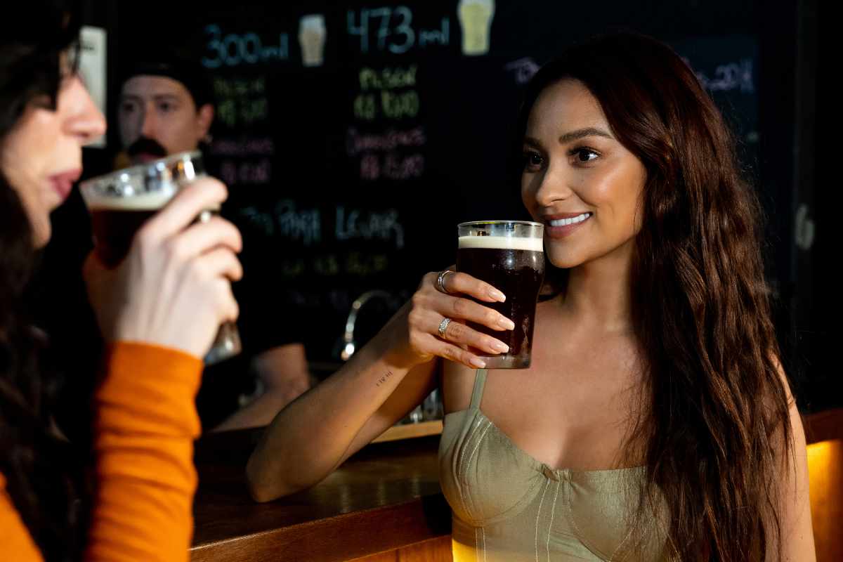 Shay Mitchell drinking beer with Camila Countinho