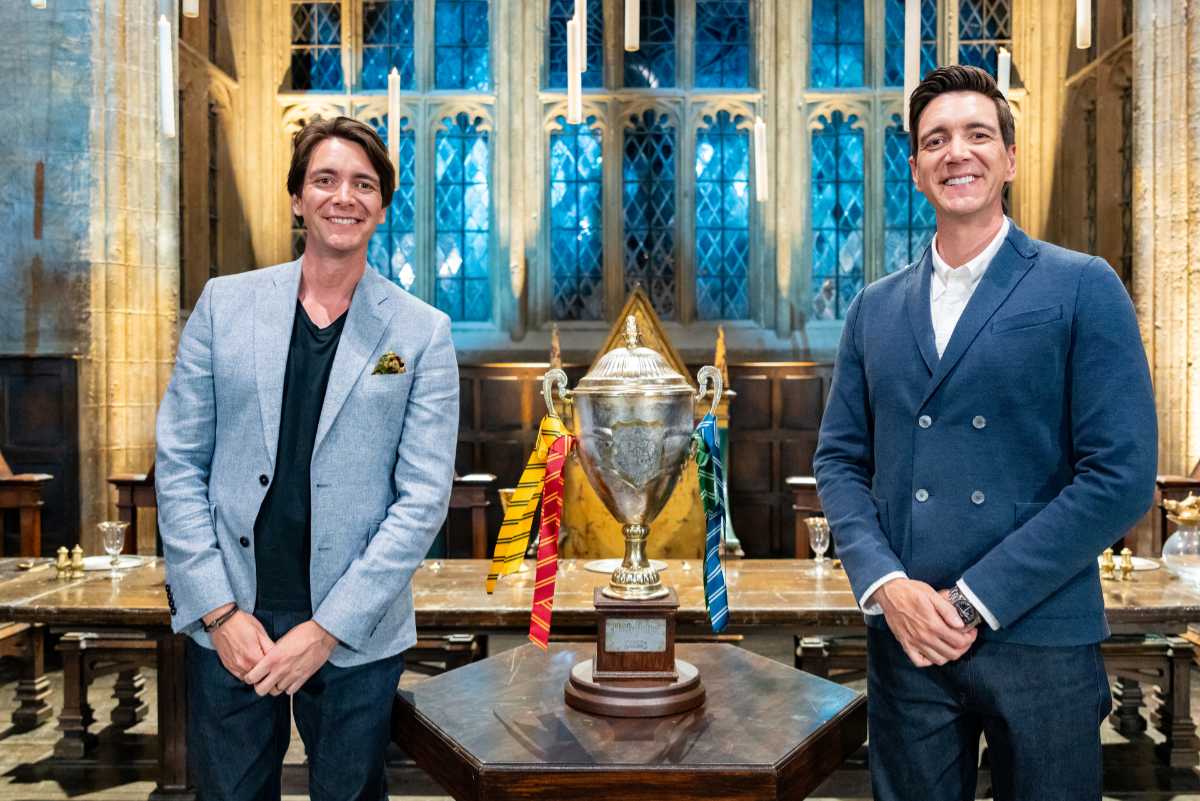 Hosts James and Oliver Phelps with the Winners Cup in The Great Hall