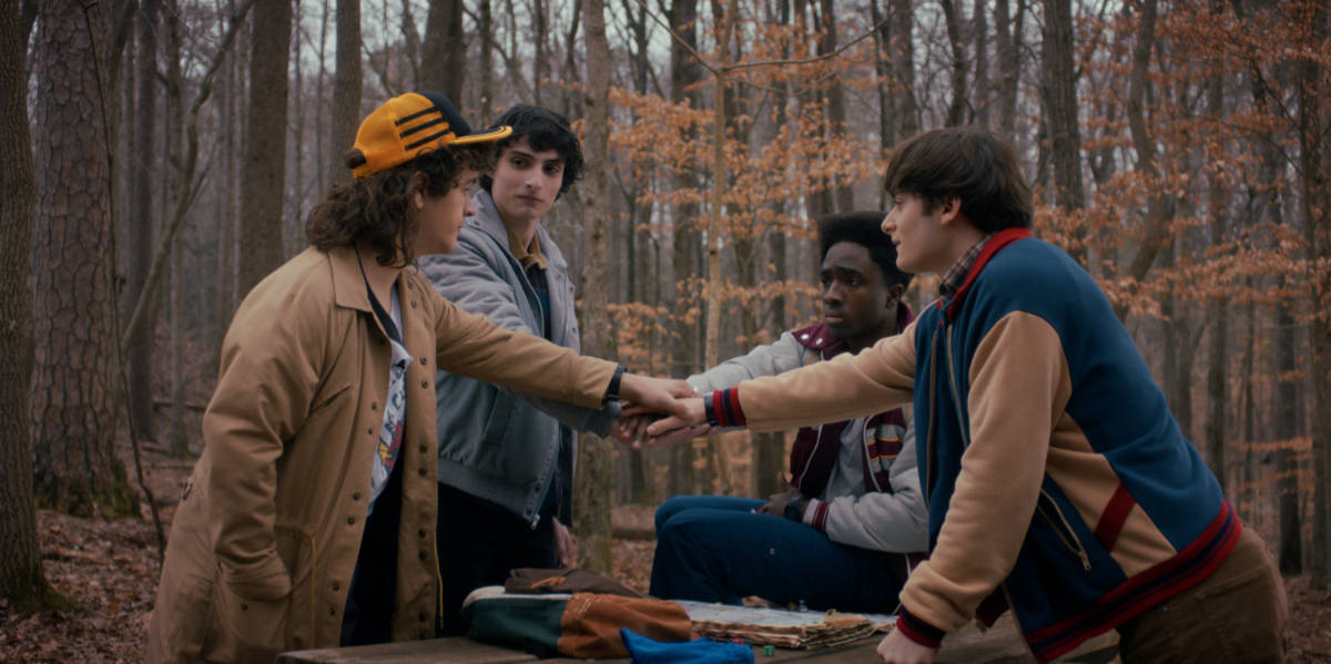 Gaten Matarazzo as Dustin Henderson, Finn Wolfhard as Mike Wheeler, Caleb McLaughlin as Lucas Sinclair, and Noah Schnapp as Will Byers