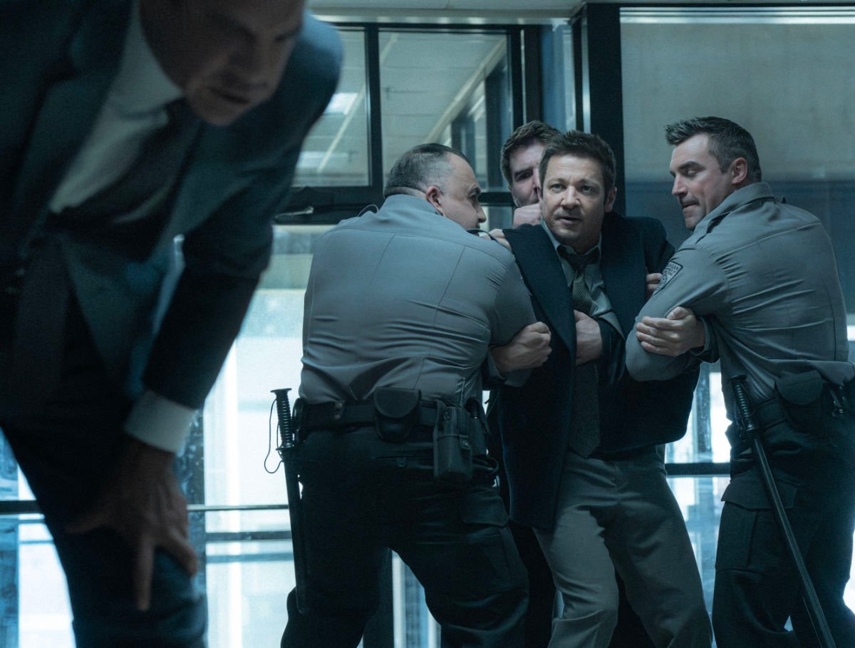 Clayton Cardenas as Torres and Jeremy Renner as Mike McLusky