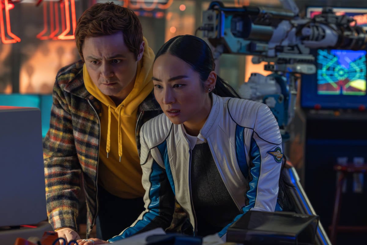 Arturo Castro as Seth Flores and Greta Lee as Eve Kim in TRON: Ares