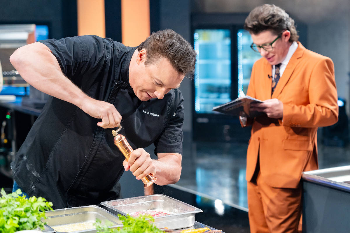 Rocco DiSpirito gets cooking as sideline reporter Justin Warner takes notes.