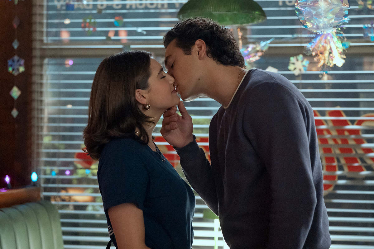 Garrett (Belmont Cameli) and Hannah (Ella Bright) kissing.