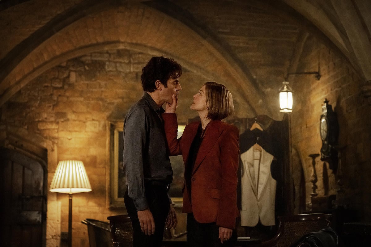 Sacha Baron Cohen as Damien Sachs and Rosamund Pike as Alex Fox in Ladies First