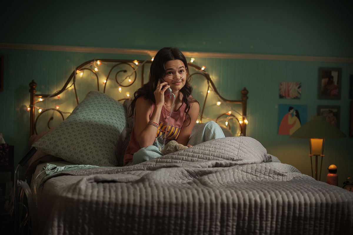 Ciara Bravo as Isabelle in bed with lights