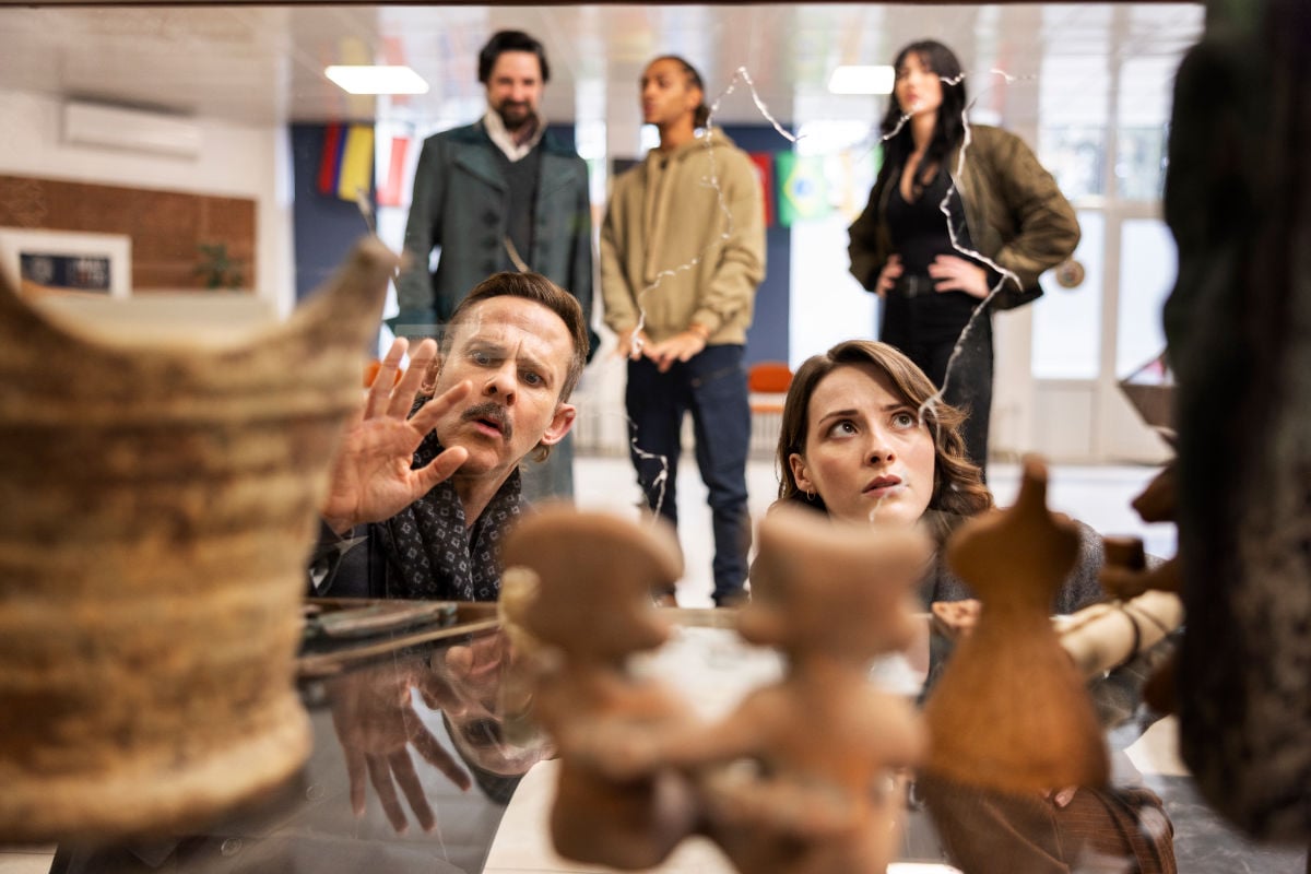 The team inspects a display case