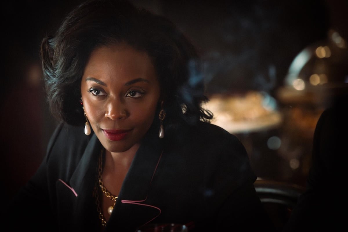 NAFESSA WILLIAMS in a suit with gold and silver earrings and necklace