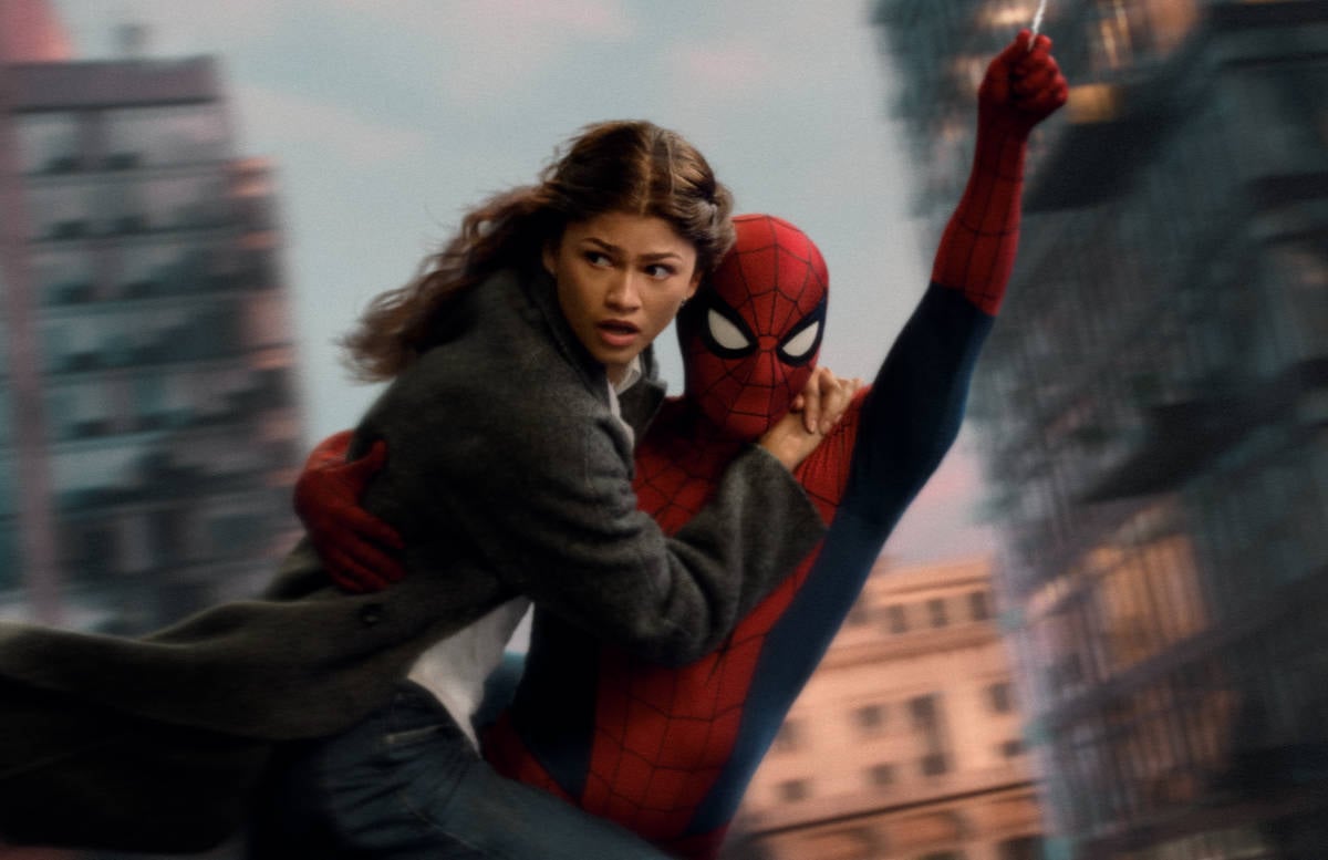 MJ (Zendaya) swings through the city with Spider-Man